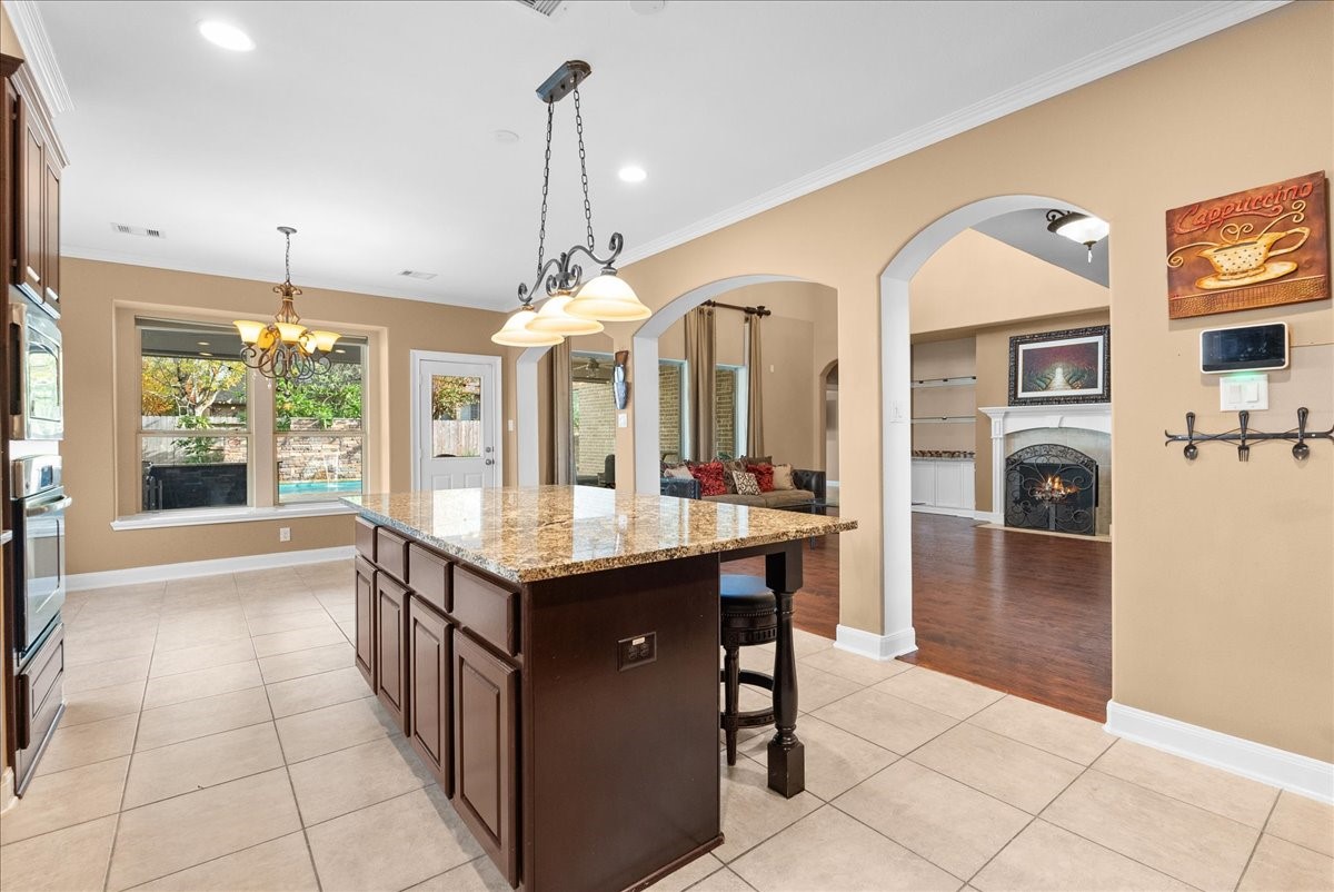 1358 Porta Rosa Lane League City, TX 77573 - Photo 10 of 48 An eat-in island kitchen showcases granite countertops, stainless steel appliances, and 42" cabinetry finished with crown molding.