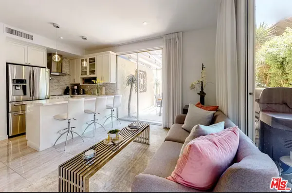 a bedroom with furniture and a large window