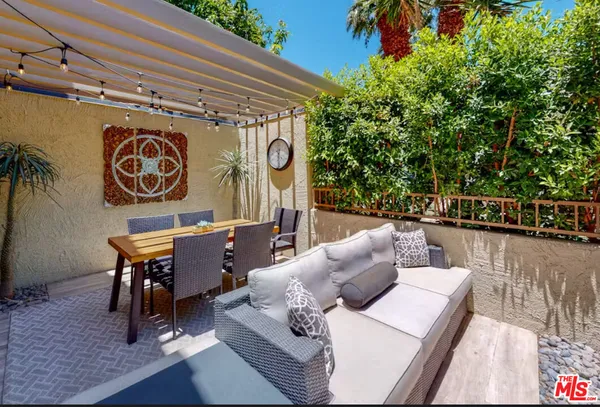 a outdoor space with patio couch and a potted plant