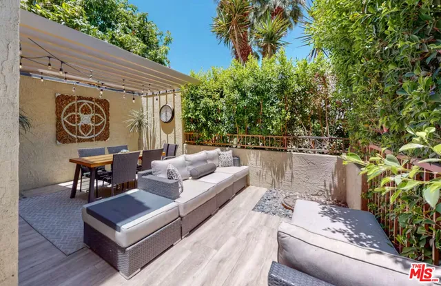 a outdoor space with patio couch and a potted plant