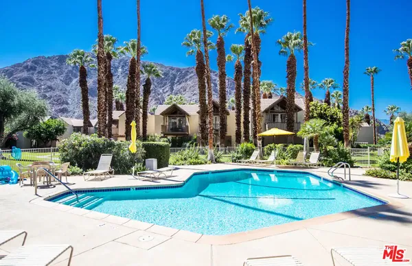 a view of a swimming pool with an outdoor space and seating area
