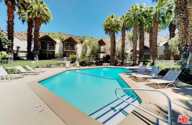 a swimming pool with outdoor seating and yard
