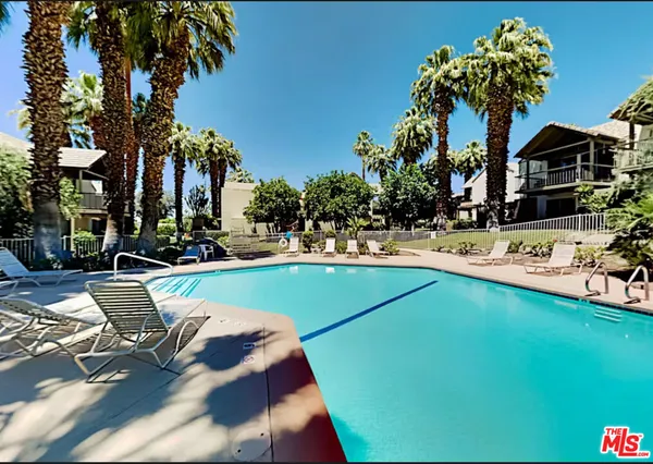 a swimming pool with outdoor seating and yard