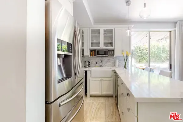 a kitchen with a refrigerator and a sink
