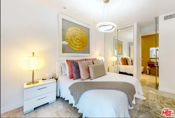 a bedroom with a bed and a lamp on table