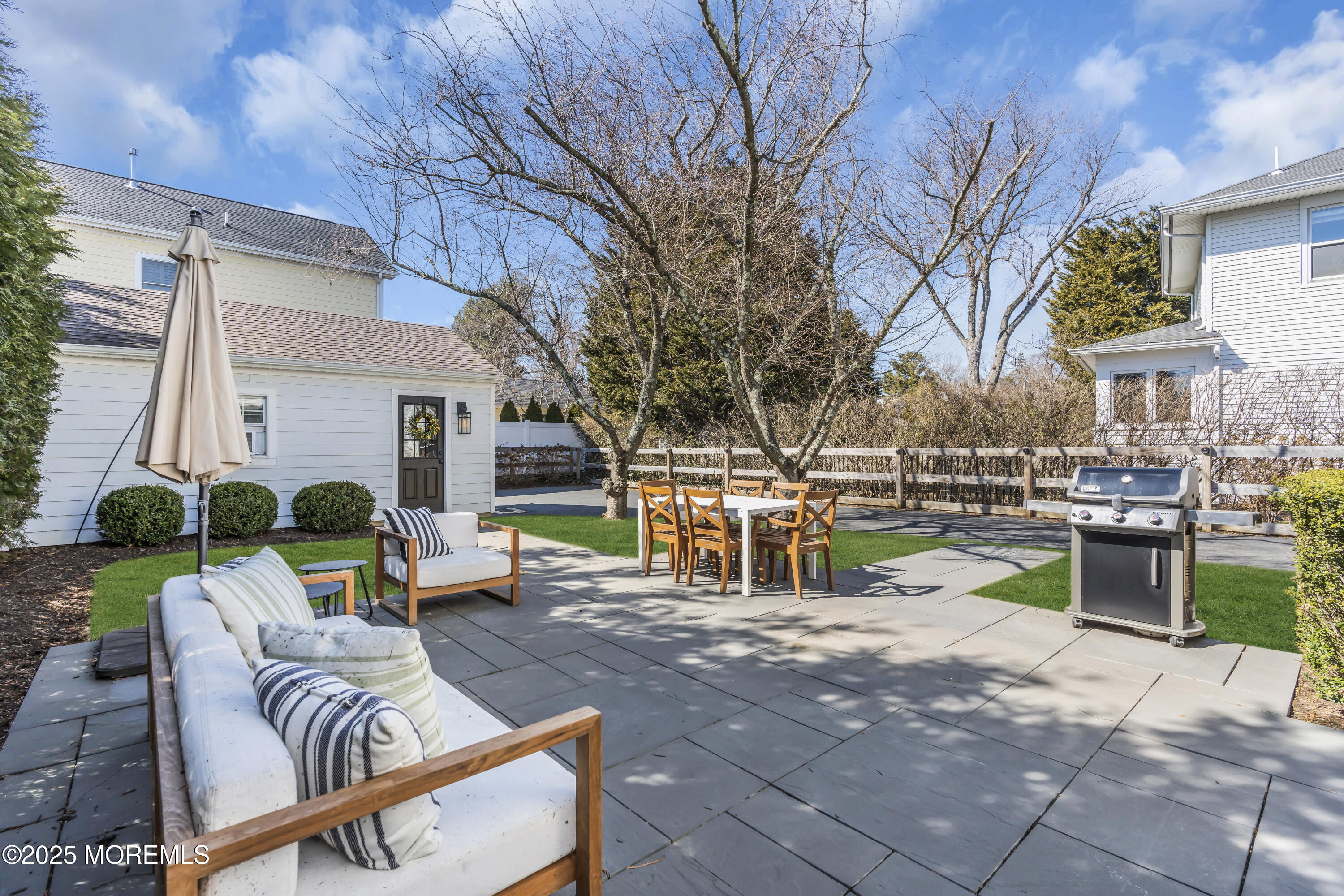 150 Hance Road Fair Haven, NJ 07704 - Photo 29 of 35 a view of a patio with dining table and chairs with wooden fence