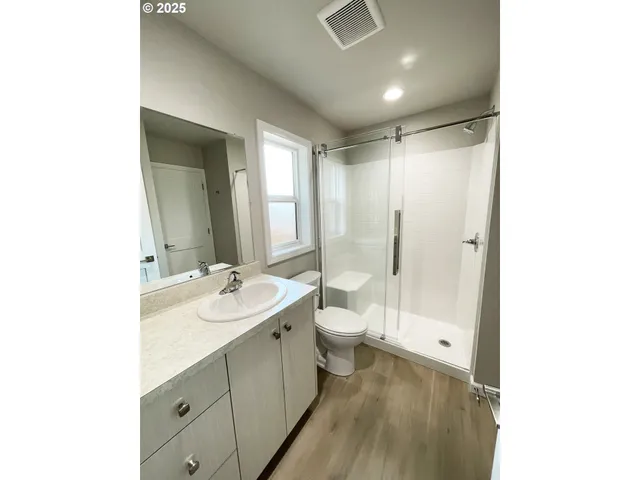 a bathroom with a double vanity sink toilet mirror and bathtub