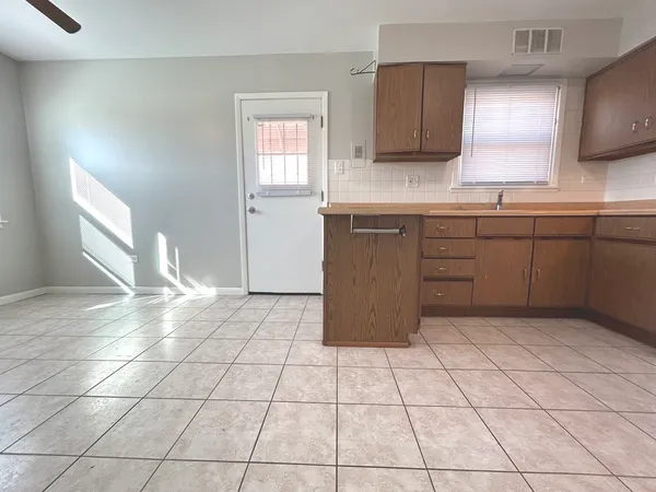 a kitchen with a cabinets and window