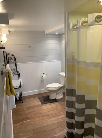a bathroom with a toilet and a shower