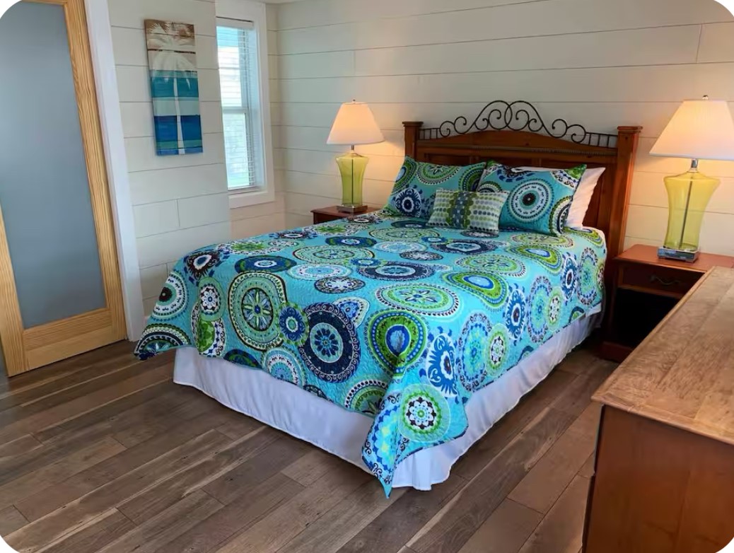 911 11th Street, Unit 2 Galveston, TX 77550 - Photo 10 of 20 a bed sitting in a bedroom next to a window