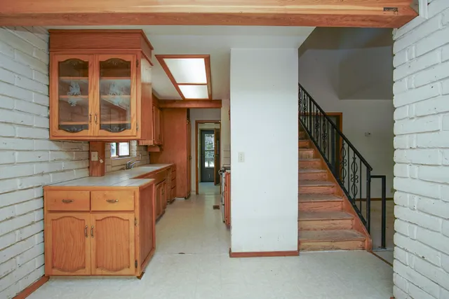 a room with a window and a kitchen