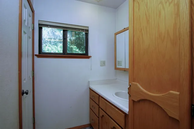 a bathroom with a tub a window and a shower