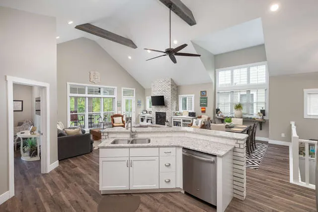 a kitchen with a sink cabinets and wooden floor