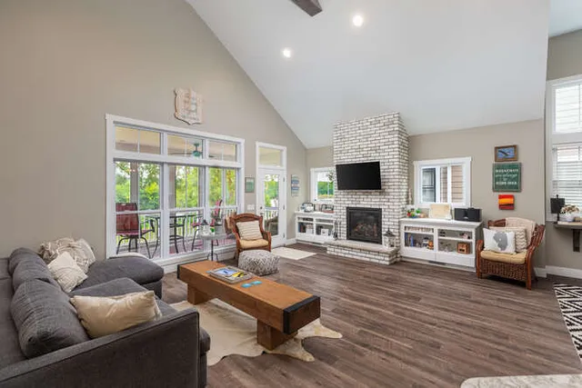 a living room with furniture a fireplace and a flat screen tv