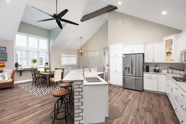 a kitchen with refrigerator cabinets and wooden floor