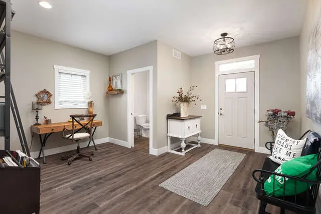 a living room with furniture and a wooden floor