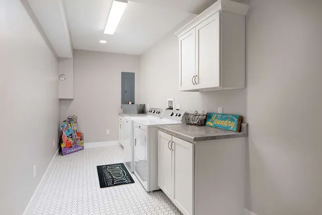 a utility room with sink dryer and washer