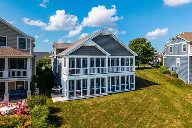 a view of a house with pool and sitting area