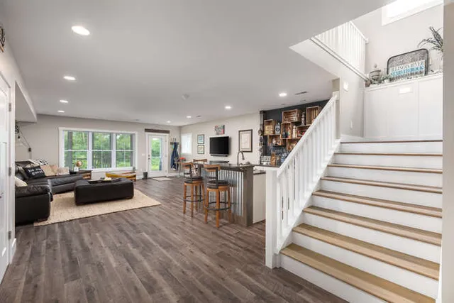 a living room with furniture and a wooden floor