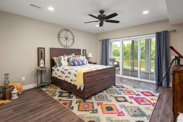 a bed sitting in a bedroom next to a window
