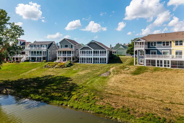 a view of a house with a big yard and large trees