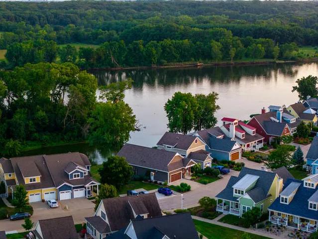 an aerial view of a house with outdoor space and lake view