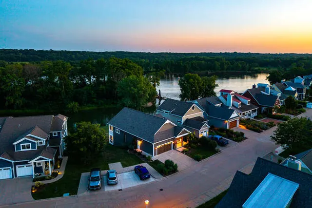 an aerial view of a house with outdoor space and lake view in back