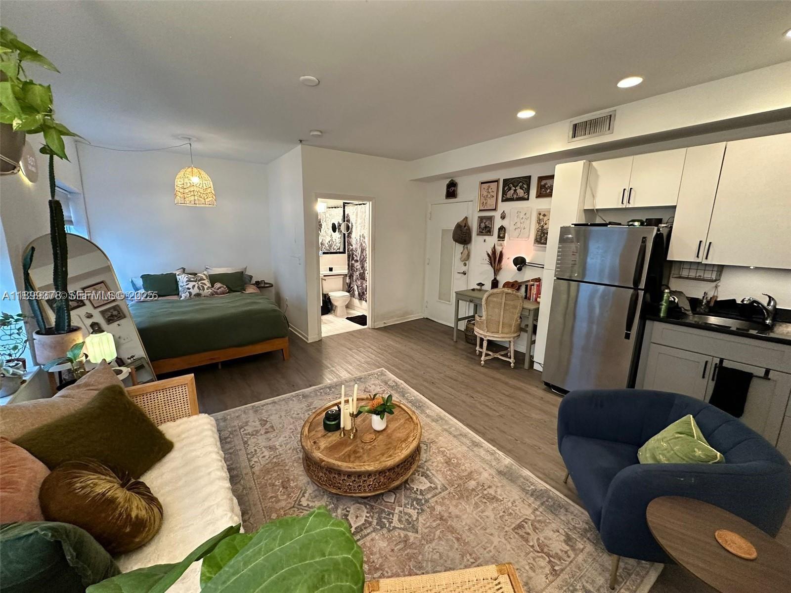 1244 Pennsylvania Avenue, Unit 103 Miami Beach, FL 33139 - Photo 1 of 11 a living room with furniture and a window