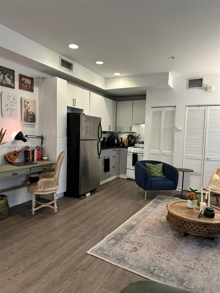 1244 Pennsylvania Avenue, Unit 103 Miami Beach, FL 33139 - Photo 2 of 11 a kitchen with refrigerator and chairs