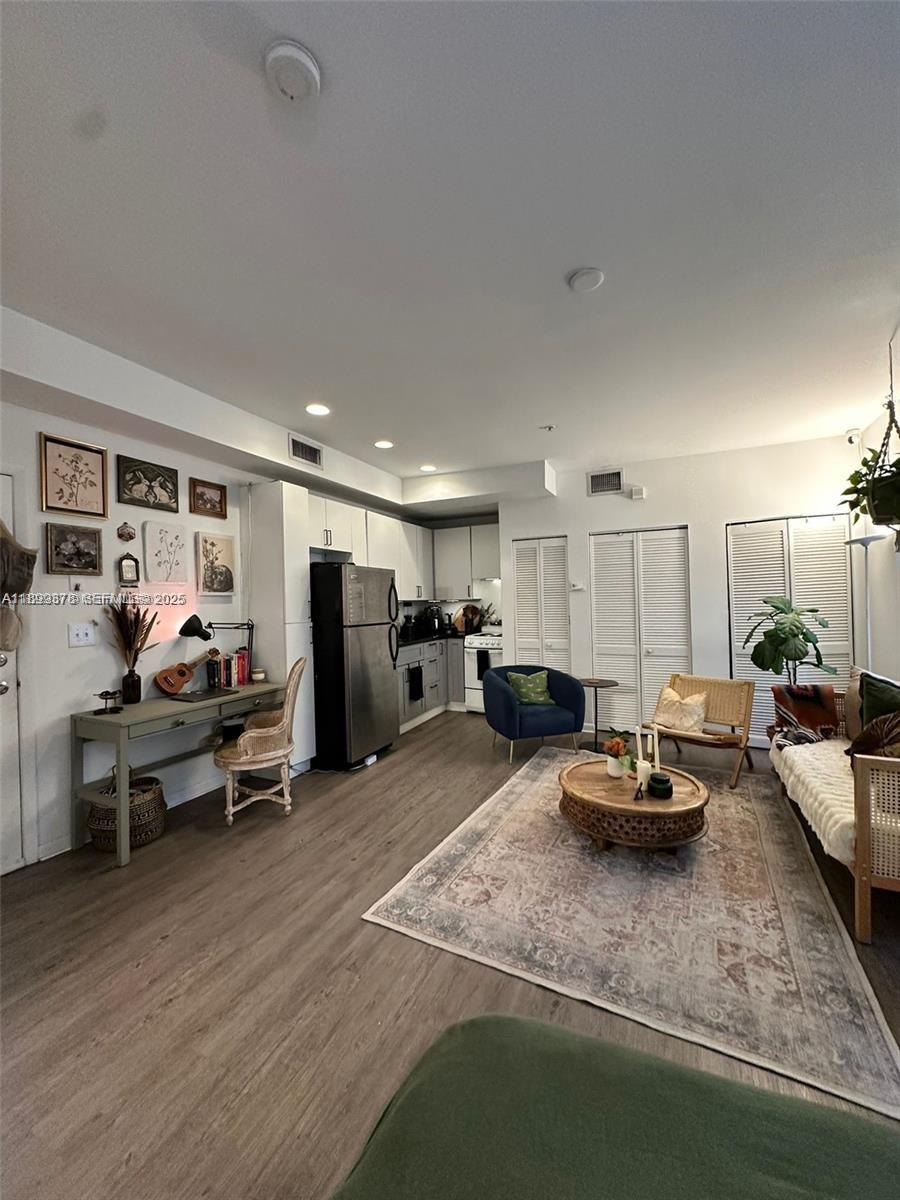 1244 Pennsylvania Avenue, Unit 103 Miami Beach, FL 33139 - Photo 3 of 11 a view of a room with wooden floor and furniture
