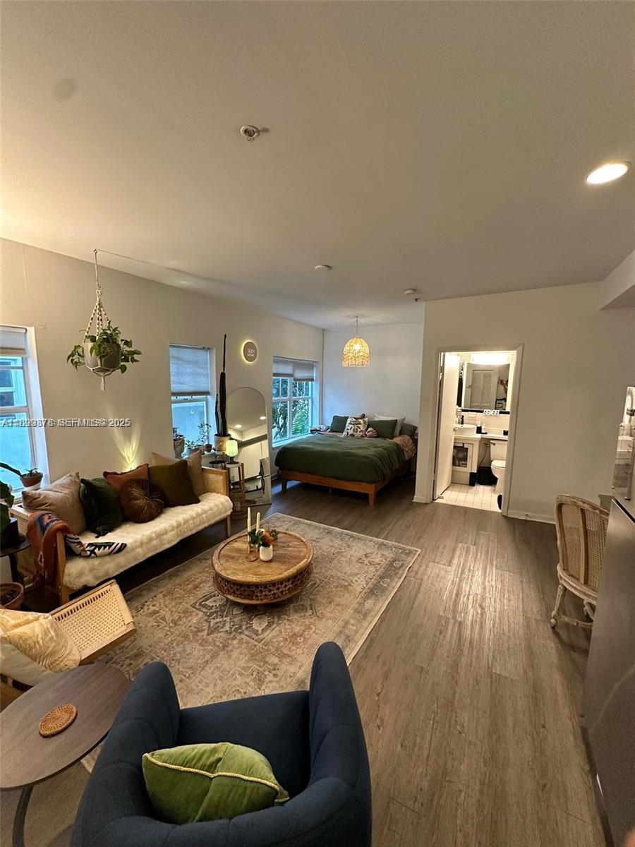 1244 Pennsylvania Avenue, Unit 103 Miami Beach, FL 33139 - Photo 6 of 11 a living room with furniture and a wooden floor