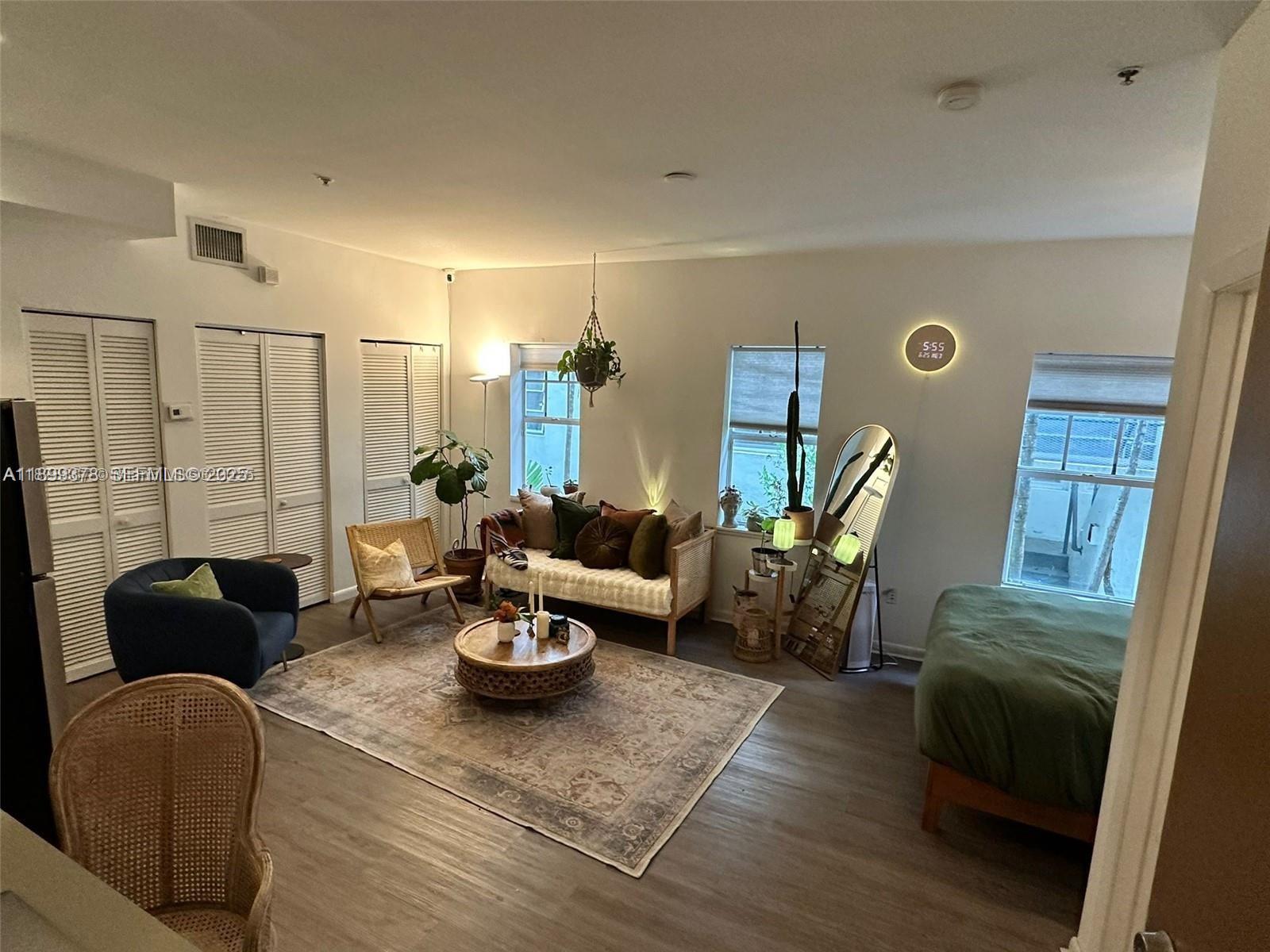 1244 Pennsylvania Avenue, Unit 103 Miami Beach, FL 33139 - Photo 8 of 11 a living room with furniture and a potted plant