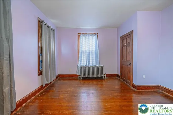 a view of a room with a wooden floor