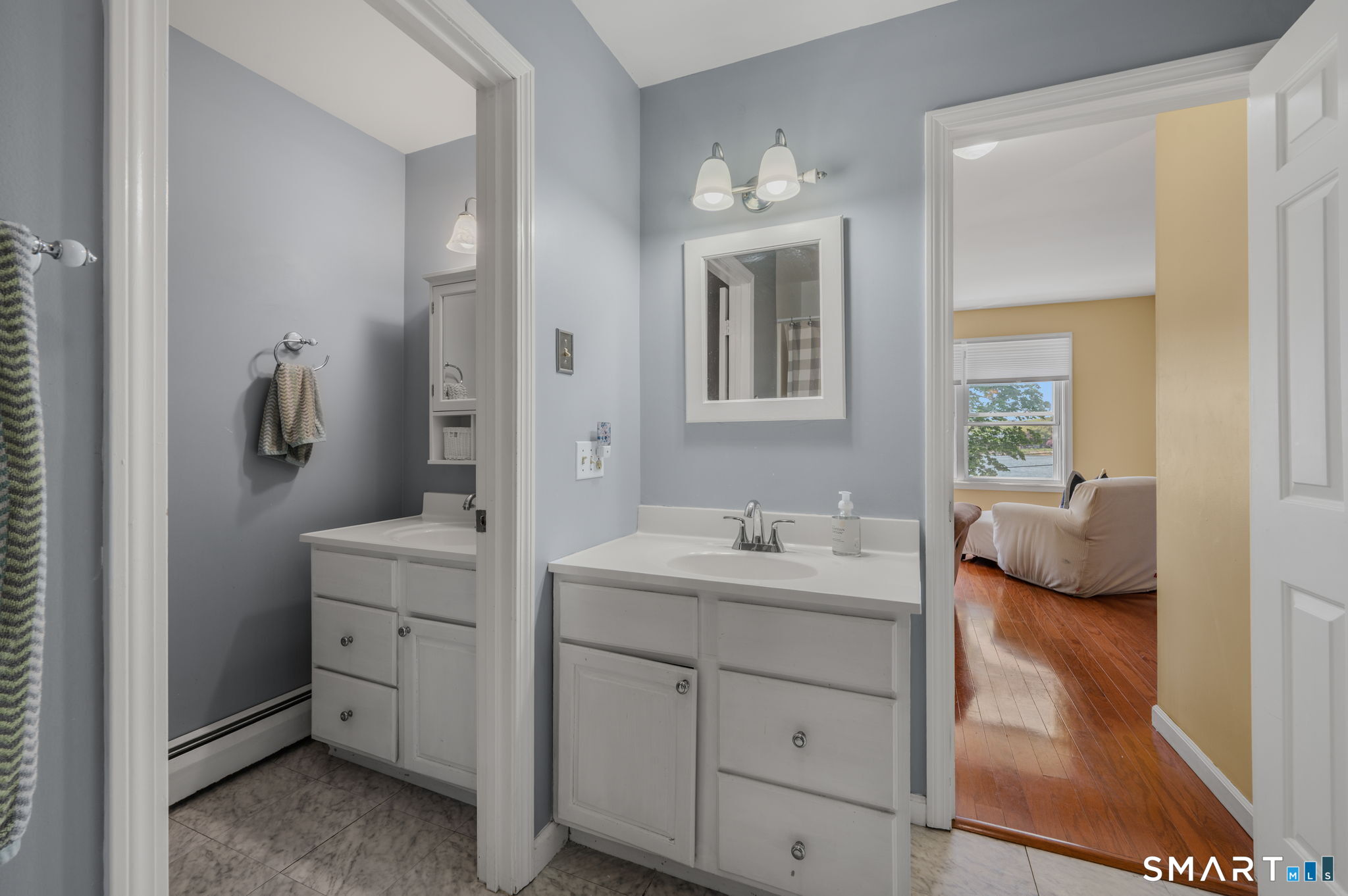 212 R Shore Road Waterford, CT 06385 - Photo 26 of 28 a en suite bathroom with a double vanity sink and mirror