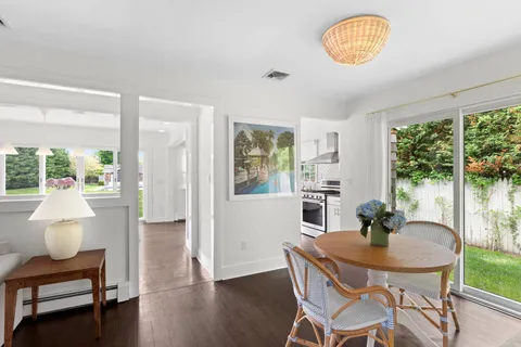 a view of a dining room with furniture window and wooden floor