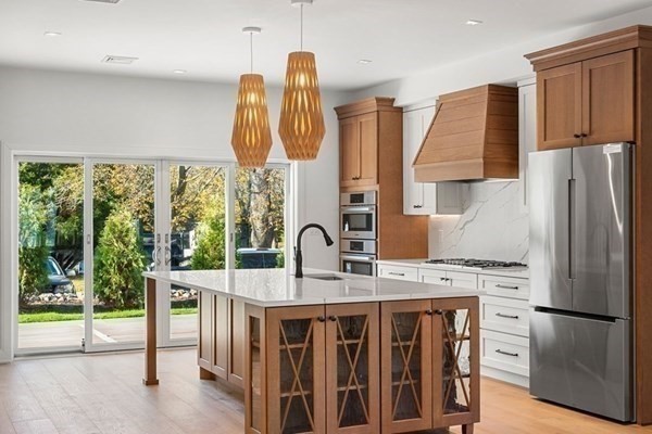 8 Orchard Road, Unit B Gloucester, MA 01930 - Photo 3 of 8 a kitchen with stainless steel appliances granite countertop a sink refrigerator and cabinets