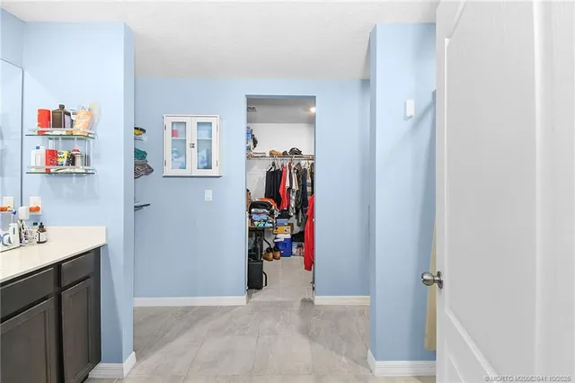 a view of a hallway with workspace and closet area