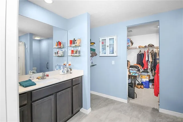 a utility room with painting on the wall and a window