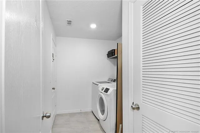 a view of a bathroom with a washer and dryer