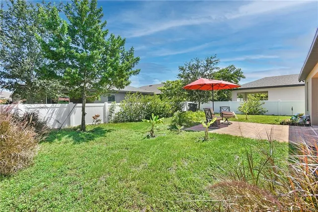 a view of a house with a yard and sitting area