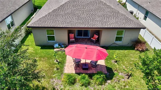 a aerial view of a house with a garden and lake view