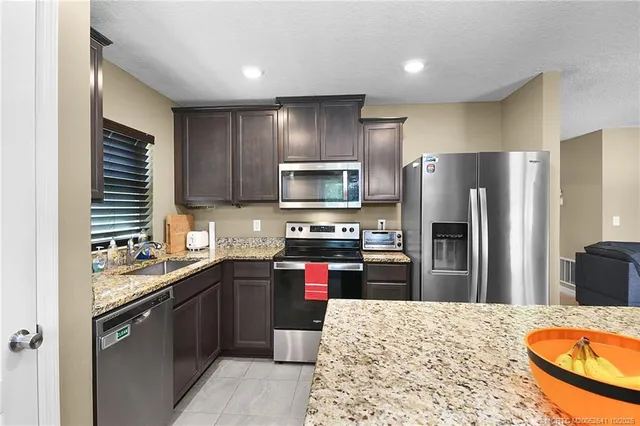 a kitchen with a sink stove and refrigerator