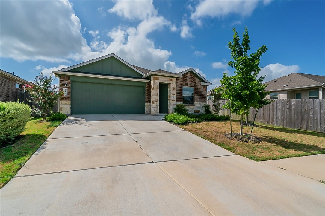 7409 Spring Ray Drive Del Valle, TX 78617 - Photo 1 of 1 a front view of a house with garden