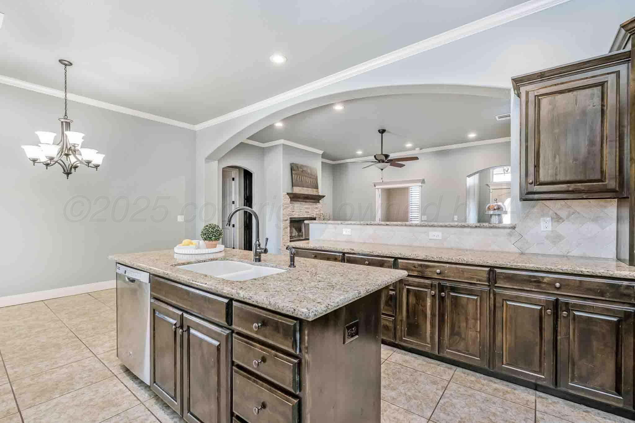 6 Cody Lane Canyon, TX 79015 - Photo 12 of 23 a kitchen that has a sink a stove and a wooden cabinets
