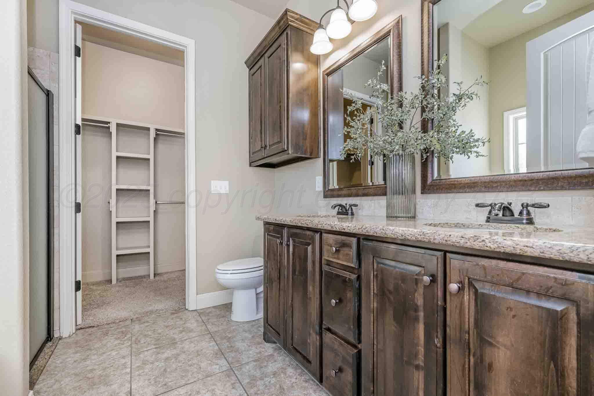 6 Cody Lane Canyon, TX 79015 - Photo 16 of 23 a spacious bathroom with a granite countertop sink a toilet and a mirror