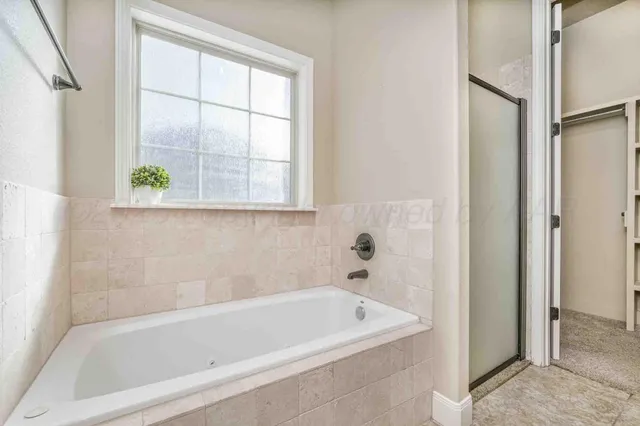 a white bath tub sitting next to a window