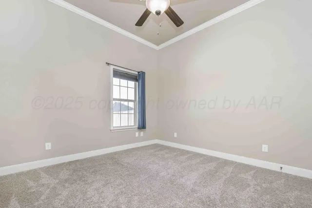 an empty room with a window and a ceiling fan