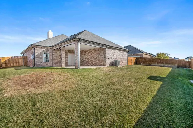 a big white house with a big yard and large trees