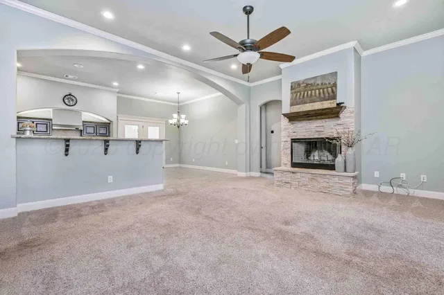 a view of a livingroom with a fireplace and a ceiling fan