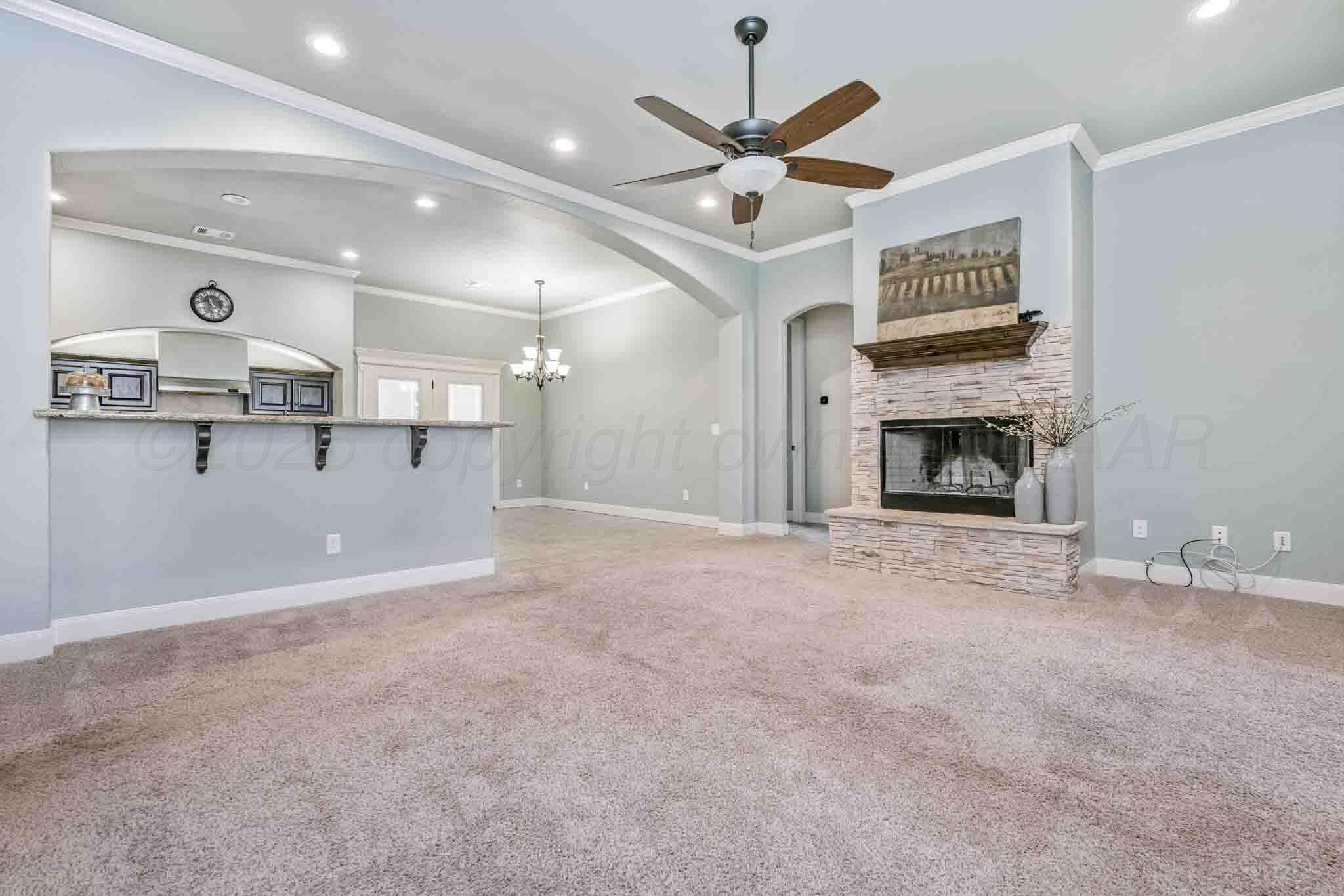 6 Cody Lane Canyon, TX 79015 - Photo 4 of 23 a view of a livingroom with a fireplace and a ceiling fan